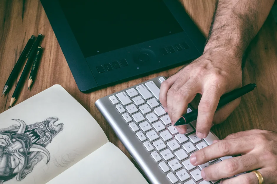 A sleek office desk setup featuring Apple devices: iMac, MacBook, and iPad.